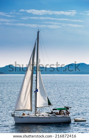 ADRIATIC SEA, CROATIA - AUGUST 21, 2014: Sailboat in Adriatic sea between Zadar and island Ugljan. Adriatic Sea separates Italian peninsula from Balkans and occupies 138.000 square kilometers.