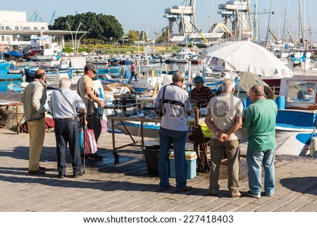 PALERMO, ITALY - OCTOBER 21, 2014: Customers and sellers buying and selling fish and sea products on  farmer\'s market on streets of Palermo city center. It is most famous Palermo market.