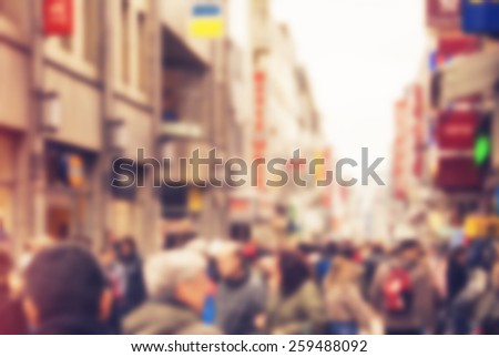 Abstract background - people shopping and walking in main shopping street in Cologne, Germany - blur effect defocusing filter applied, with vintage instagram look.