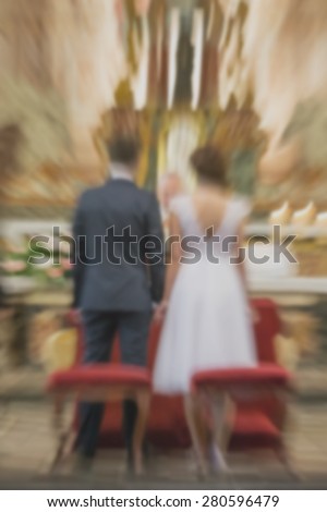 Young couple getting married in christian church - religious wedding - radial zoom blur applied, defocused, with washed instagram filter