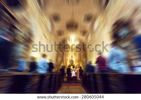 Young couple getting married in christian church - religious wedding - radial zoom blur applied, defocused, with instagram filter