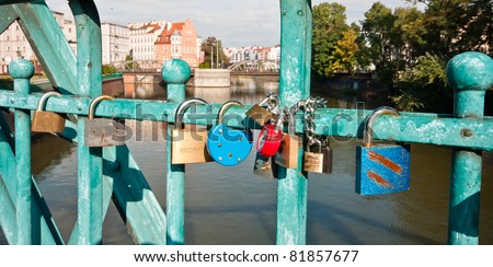 WROCLAW, POLAND - OCT 7: Padlock hanging on Tumski bridge on October 7, 2009 in Wroclaw, Poland. People traditionally attach a padlock to the bridge as sign of love after a wedding ceremony.