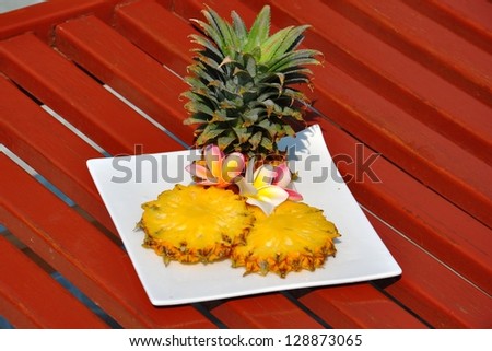 Pineapple. Beautifully sliced ??pineapple on a wooden bench.