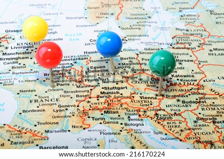 Macro shot of a map showing main western Europe cities with a colorful tack