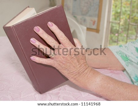 Old woman hand opening a book