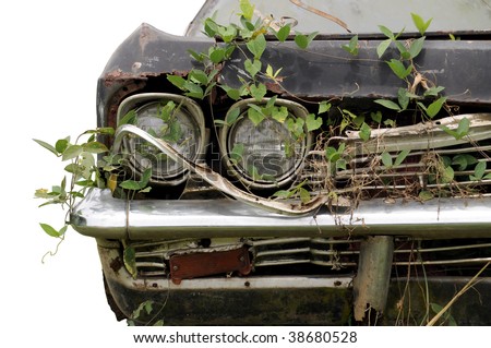Close up shot of a junked car left in a field