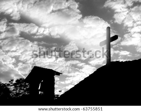 Silhouette of a chapel with a ray of light hitting the cross from the sky