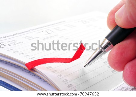 Hand writing on an appointment  book isolated on white