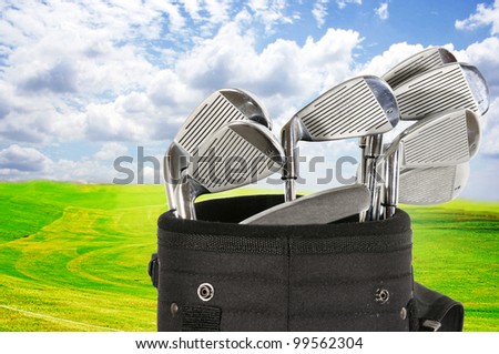 Golf bag with clubs against a beautiful fairway and a blue sky