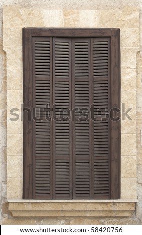 Old window with brown shutters.