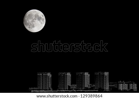 Closeup of full moon over the city