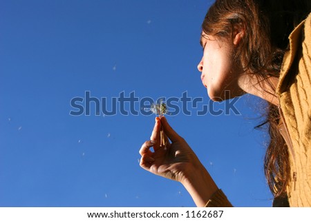 A picture of a young woman blowing a Dandelion plant seeds. A good way of showing liberty and lightness.