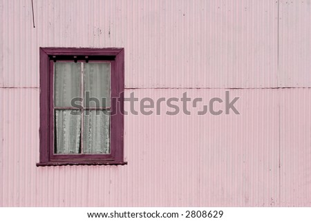 Window in a zinc metal wall, a typical train station construction. Negative space for copy. Violet tones.