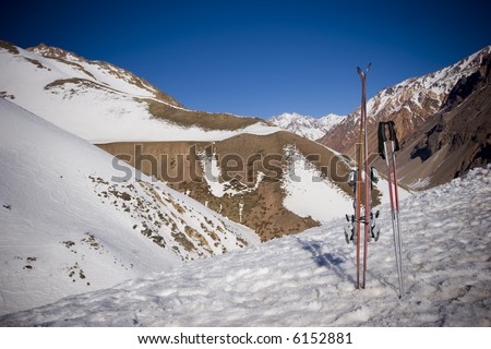Ski gear with snowed mountailns background (vignetting effect)