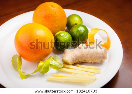 Still life with fruit platter. Orange, lemon, lime, ginger, peel