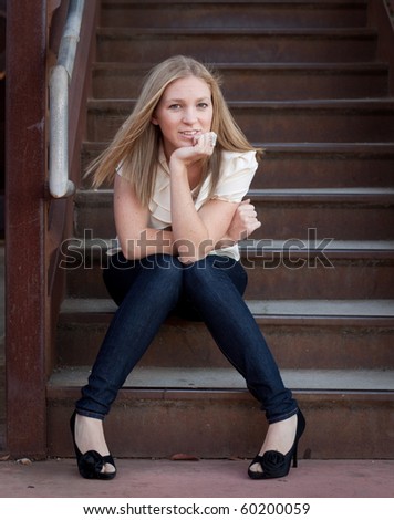 Stylish woman sitting on steps.