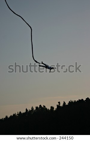 Silhouette of a person falling down to earth during bungee jumping