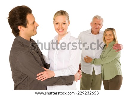 husband wife father in law mother in law standing on white background