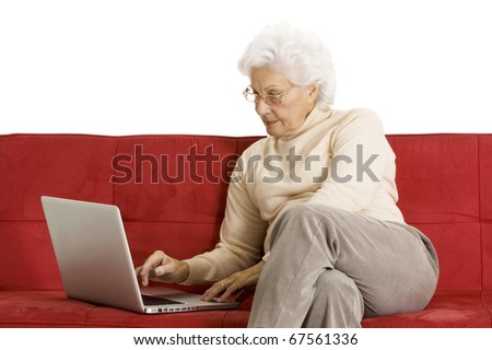 elderly woman on the couch with laptop