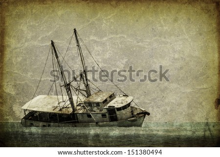 Vintage looking picture of a capsized fishing boat in the caribbean