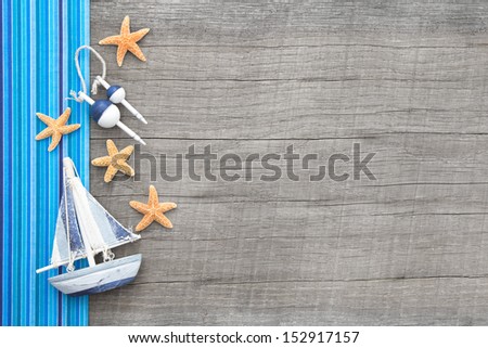 Sailboat and starfishes on wooden background for a travel card - also concepts for sailing and traveling