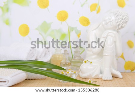 Massage oils and towels with Buddha figurine