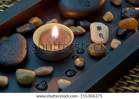 Romantic candlelight with chinese or asian characters - spa decoration with stones