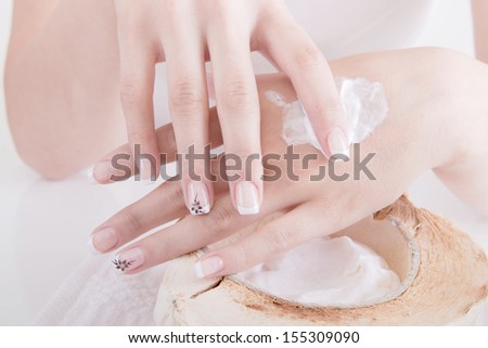 Woman applying hand lotion