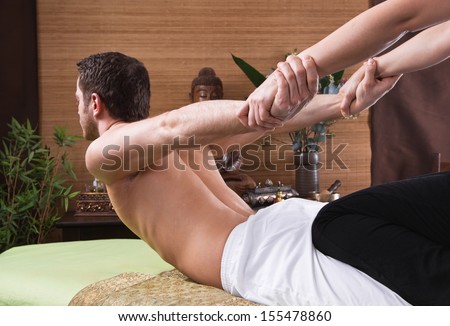 Thai woman making massage to a man