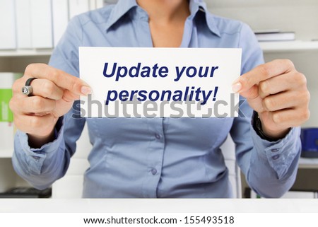 Hands of woman holding sign: Update your personality