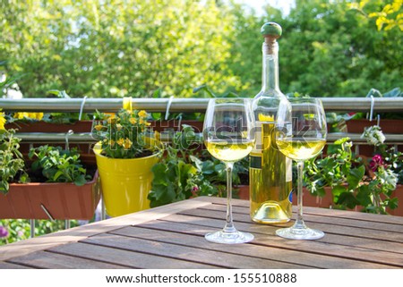 White wine served for two in garden.