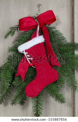 Handmade Santa boot on pine branch background