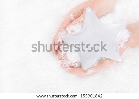 Woman holding iced star in palm *** Local Caption *** Woman holding china angel in her palm