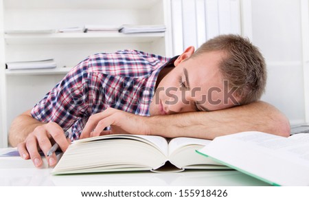 Man sitting in office stretching Man sitting in office sleeping