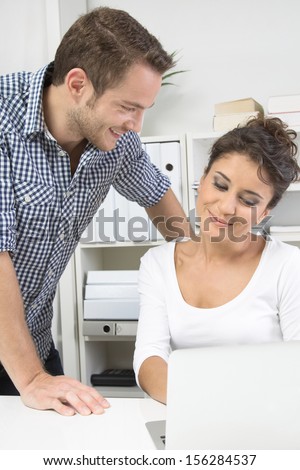 Caucasian young man flirting with his colleague in office