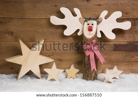 Christmas stars and elk with snow on wooden background