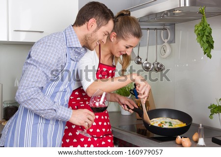 Couple in love cooking together in the kitchen and have fun