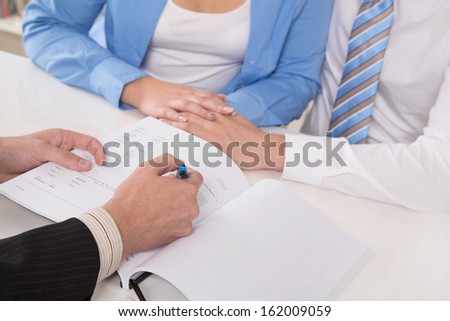Terms and conditions of contract: close up of hands signing documents or paper