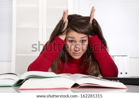 Young businesswoman has concentration problems at studying or at work
