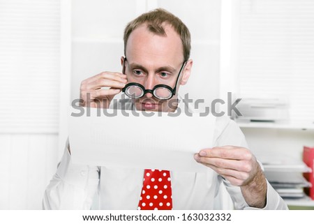 Tax consultant is controlling business numbers with big glasses also like a controller or examiner for tax but funny.