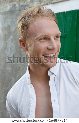 Portrait of young happy smiling blond caucasian man - attractive.