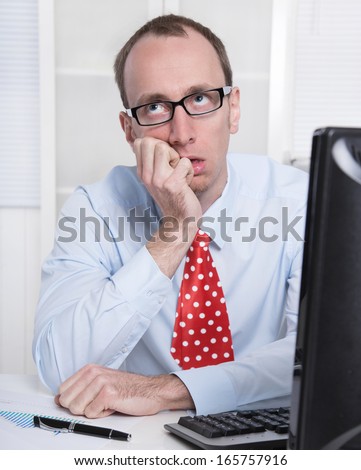 Frustrated business man with tie and glasses at Office.