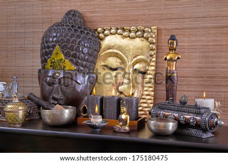 Asian decoration with buddha and candles in gold and brown in thai massage.