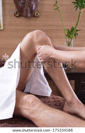 Man at foot massage in a original thai spa