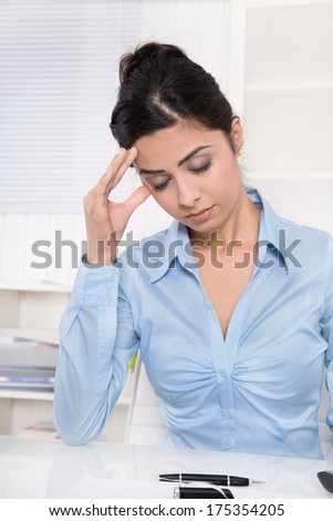 Attractive young asian secretary has migraine or headache at office.
