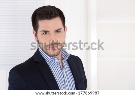 Face of a handsome dark haired business man in the office