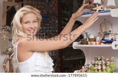 Young woman on summer vacancies shopping souvenirs.