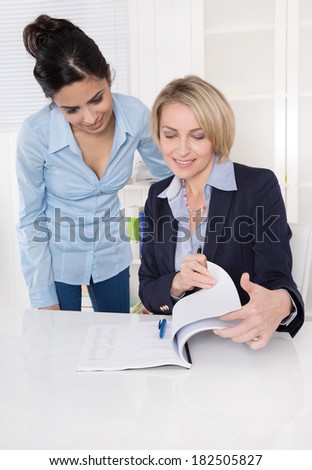 Happy teamwork: Two business woman talking.