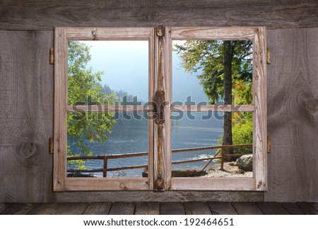 House on the sea in the alps - old rustic wooden window.