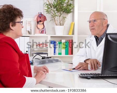 Portrait: older doctor with experience talking with senior woman.